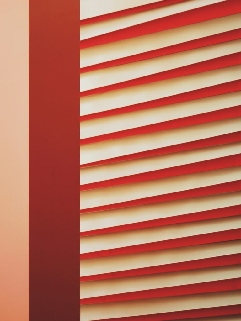 a-close-up-of-a-red-and-white-wall-hggz3xoyebw