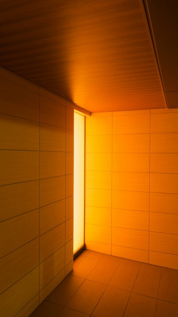 an-empty-room-with-a-light-coming-through-the-window-okwc2garlwu