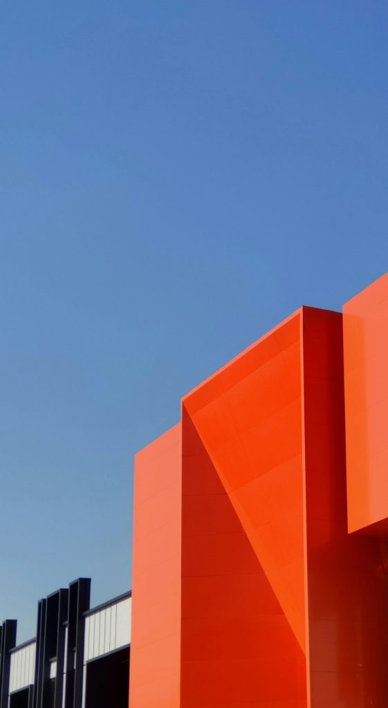 pink-concrete-building-under-blue-sky-during-daytime-b4udxn2ndzq